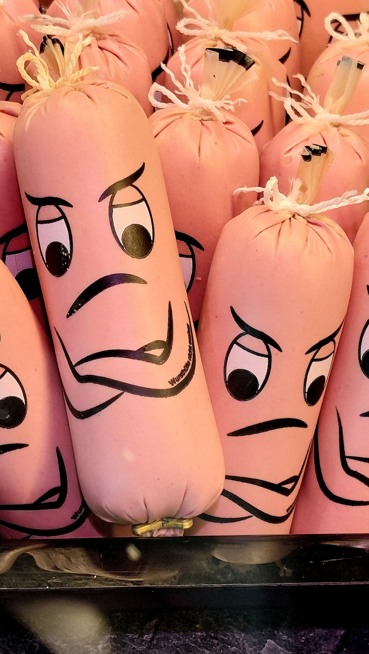 Die beleidigte Leberwurst:

In der Theke liegt sie schmollend da,
die Leberwurst, beleidigt - na klar.
Bei Macher im Laden, geschniegelt und fein,
will sie heut’ einfach nicht fröhlich sein.

..Warum“, so grummelt sie leise vor sich,
..glotzen mich alle so hungrig an, unerquicklich!“
Die Salami prahlt: ..Ich werd gleich gekauft!“
Die Leberwurst seufzt: ..Na toll… bin ich heute drauf.“

Der Schinken kichert im Kühlregal:
..Ach komm, nun lach doch ein einziges Mal!“
Doch sie zieht ihre Wursthaut noch krummer und schief:
..Ich bin beleidigt! Und das hier massiv!“

Ein Kind zeigt auf sie: ..Mama, guck mal ihr Gesicht!“
Da zuckt sie kurz - doch lachen will sie nicht.
Sie denkt sich nur: ..Wenn ihr wüsstet, warum -
ich wollte Croissant werden. Jetzt lieg’ ich hier rum.“

Der Metzger ruft: ..Wer nimmt die Diva mit?“
Da blinzelt sie stolz mit dramatischem Schritt:
..Nur wer mich würdigt, versteht meinen Wert -
beleidigte Leberwurst wird nicht verzehrt!“

Und so liegt sie weiter, geschniegelt und rund,
die schmollende Königin im Thekenverbund.
Doch heimlich hofft sie, ganz still und sacht:
dass jemand sie liebt - trotz Schmollergesicht und Schmacht.
