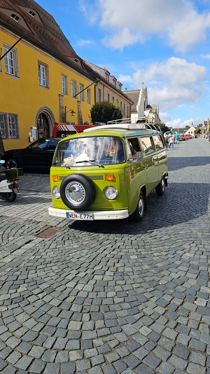 Jede Menge automobile Schätze auf dem Kemnather Stadtplatz

Ein echtes Paradies für Oldtimerfreunde gab es am Samstag beim großen Oldtimertreffen in Kemnath zu erleben. Ab 10 Uhr gehörte der wunderschöne historische Stadtplatz den automobilen Schätzen vergangener Jahrzehnte. Bei bestem Oldtimerwetter präsentierten sich die liebevoll gepflegten Fahrzeuge vor einer traumhaften Kulisse – und natürlich ließen sich das auch jede Menge Zuschauer nicht entgehen.

Dicht an dicht standen die Besucher entlang des Stadtplatzes, als ein Klassiker nach dem anderen zur Fahrzeugvorstellung vorfuhr. Dabei gab es nicht nur jede Menge Chrom, glänzenden Lack und den unverwechselbaren Klang alter Motoren zu bestaunen, sondern auch viel Wissenswertes zu hören.

Wie jedes Jahr hatte Elmar Högl das Mikrofon fest im Griff. Souverän und mit enormem Fachwissen stellte er die einzelnen Fahrzeuge vor, erzählte von Baujahren, Motorisierung und technischen Besonderheiten und hatte dabei immer wieder interessante Details zu den Oldtimern parat.

Und eigentlich ist Elmar Högl aus dem Kemnather Oldtimertreffen kaum wegzudenken. Er ist nicht nur die bekannte Stimme am Mikrofon, sondern zugleich Hauptorganisator und so etwas wie das „Herz“ des Treffens. Gemeinsam mit dem KEM-Verband und der Stadt Kemnath sorgt er dafür, dass die Freunde historischer Fahrzeuge Jahr für Jahr in Kemnath zusammenkommen.

Zur Fahrzeugvorstellung gehörte natürlich auch die Übergabe der Urkunden. Diese Aufgabe übernahm Hermann Schraml, unterstützt von Stefan Wöhrl.

Und besser hätte es an diesem Vormittag eigentlich kaum passen können: herrliches Wetter, ein voller Stadtplatz, viele begeisterte Zuschauer und mittendrin jede Menge automobile Zeitgeschichte auf zwei und vier Rädern.

Nach der Vorstellung blieb noch genügend Zeit, die Oldtimer aus nächster Nähe zu betrachten, mit den Besitzern ins Gespräch zu kommen und natürlich jede Menge Fotos zu machen.

Am Nachmittag wartete dann bereits der nächste Höhepunkt auf die Teilnehmer. Um 13:15 Uhr machten sich die historischen Fahrzeuge zur gemeinsamen Ausfahrt auf den Weg. Über Berndorf, Haidenaab und Weidenberg führte die Tour unter anderem nach Goldkronach, wo eine längere Rast eingelegt wurde, bevor es schließlich wieder zurück nach Kemnath ging.

Und jetzt viel Spaß beim Durchklicken durch unsere Bilder vom Kemnather Oldtimertreffen 2026!